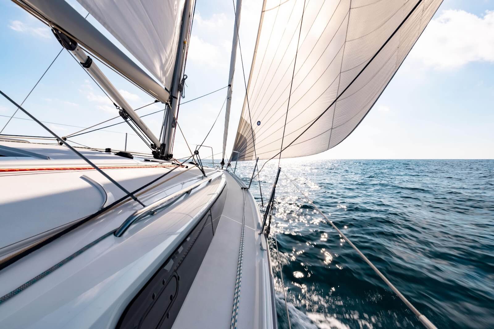 sailboat gliding towards sunset