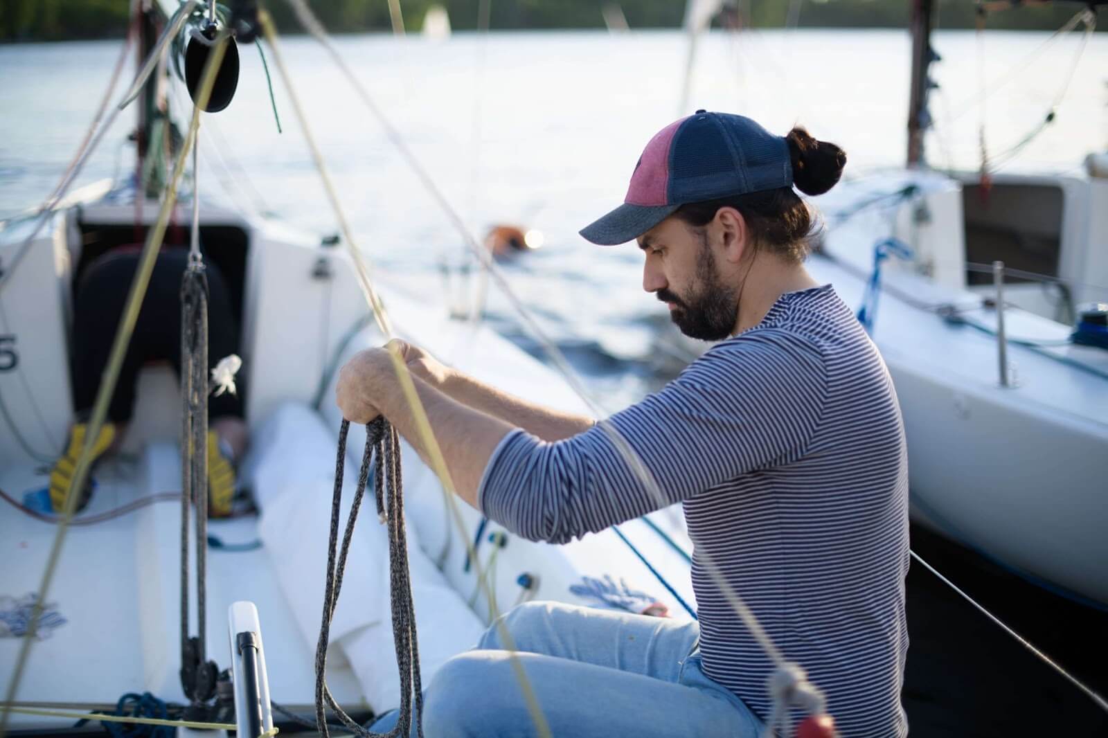 Student sailor tying a knot to as he takes the ASA 101 test.